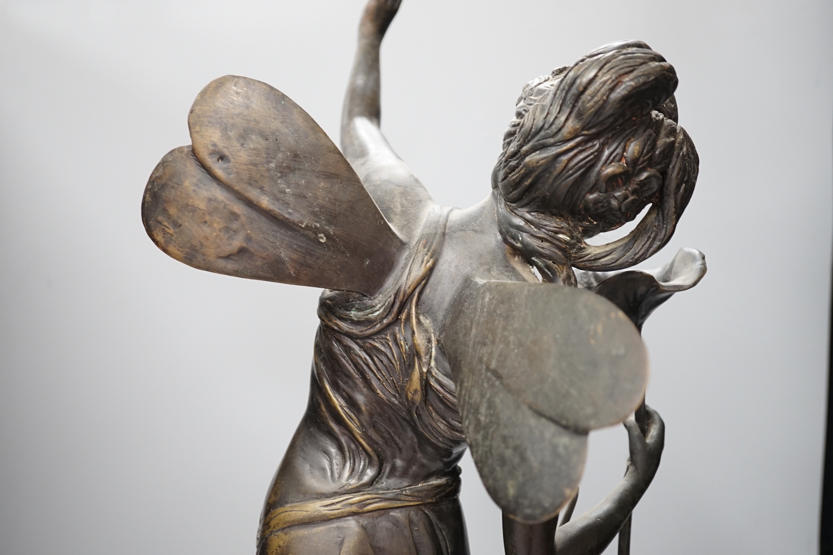 An Art Nouveau style fairy on a black marble base, 63.5cm high